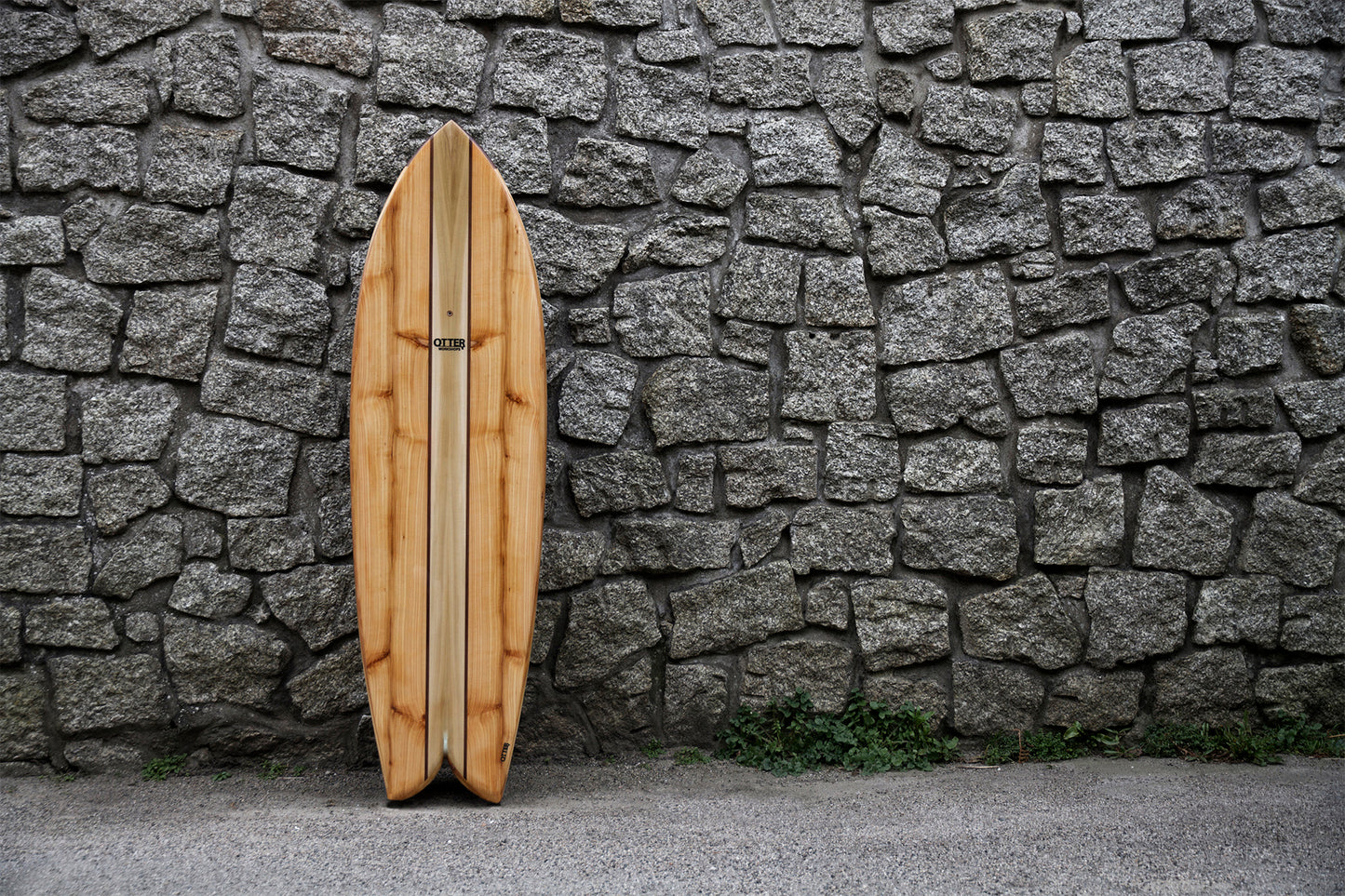 クラシックなフィッシュデザインを現代の技術で再構築。職人の手仕事によって組み上げられた中空構造（ホロー）の木製サーフボード（天然木）は、特徴的なスワローテールと滑らかなレールワークにより、見た目の美しさと波の上でのパフォーマンスを両立させる上質なクラフトマンシップを体現している。